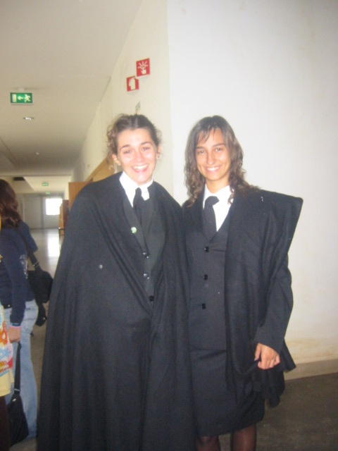 Andreia and another female student are wearing traditional university gowns